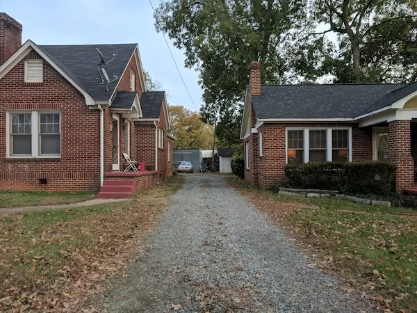 The Drakeford Company hopes to place a six-unit development behind these two homes. (Photo by Ryan Pitkin)