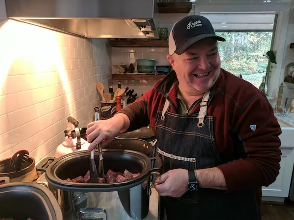 Peter Taylor at his south Charlotte home, preparing braised short ribs in a slow cooker. (Photo by Ryan Pitkin)