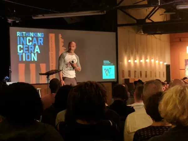 Toussaint Romain addresses a crowd of around 200 people at Warehouse 242 on Tuesday.