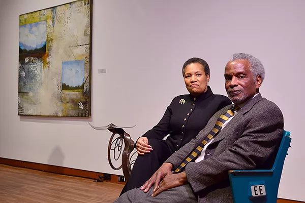 The Diamonds sit in seats pulled from the old Charlotte Colisuem and repurposed by local artist Ben Parrish. Behind them is Cheryl Warrick’s “No Wealth but Life.”