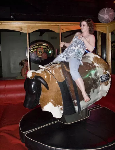 URBAN COWGIRL: The mechanical bull in Daisy Dukes - ANGUS LAMOND