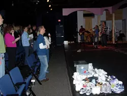 Watershed congregation listens to an alt-rock church band at Actor's Theatre. - ANGUS LAMOND