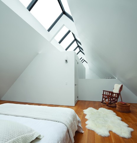 A loft bedroom under the rooftop skylight. - PAUL WARCHOL