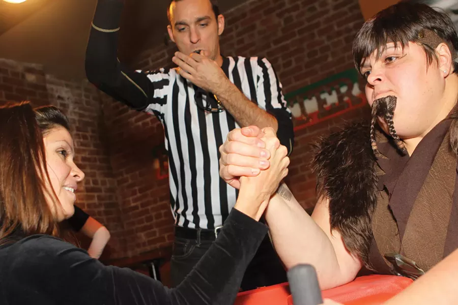 An aspiring amateur takes on BRAWL champ The Beer-barian while referee Michael Wilcock officiates at the BRAWL Ball - on December 3 at the Bridgewater Bar & Grill in Kingston.