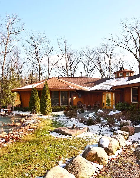 Because the Umbrella House backs into the woods, it lacks a backyard, but it is fronted by a spring-fed pond and seating area. - DEBORAH DEGRAFFENREID
