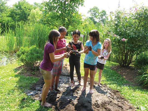 Celebrating Mud Day last May at the natural playscape at the Esopus Library in Port Ewen. - LOIS INGELLIS