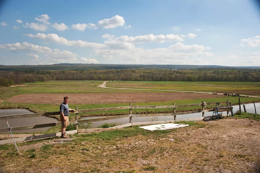 Chris Kelder overlooking the creek that flooded his fields in Accord last fall. - ROY GUMPEL