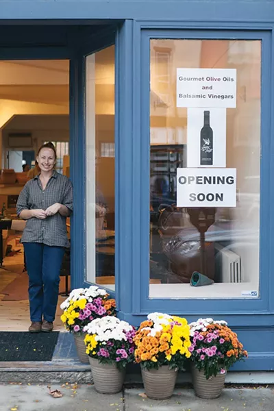 Christine Donohue prepares her store Savor the Taste for a grand opening. - THOMAS SMITH