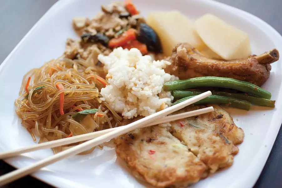 Clear yam noodles, Korean veggie pancake, string bean, pork chop, turnips, tofu with mushroom and carrots, and rice at Seoul Kitchen. - ROY GUMPEL