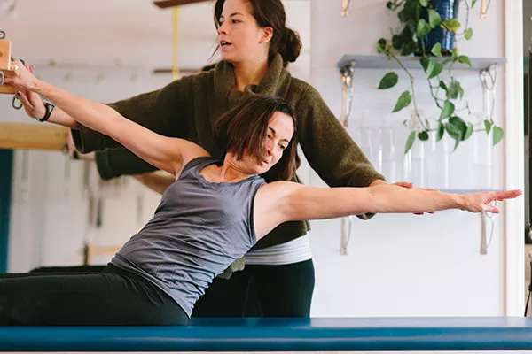 Dawn Shapiro stretches as Kate Fleck intructs at Rhienbeck Pilates. - THOMAS SMITH