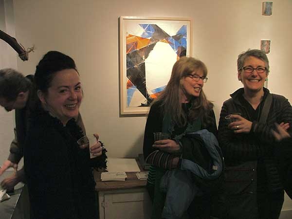 People gather around the work of Ken Gray at the "Bent" exhibition opening at Imogen Holloway Gallery during Saugerties First Friday.