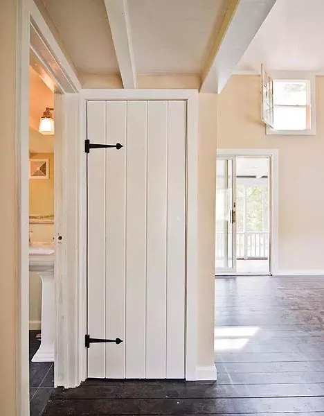 Period replica iron strap hinges were chosen to mimic the original style of the house.