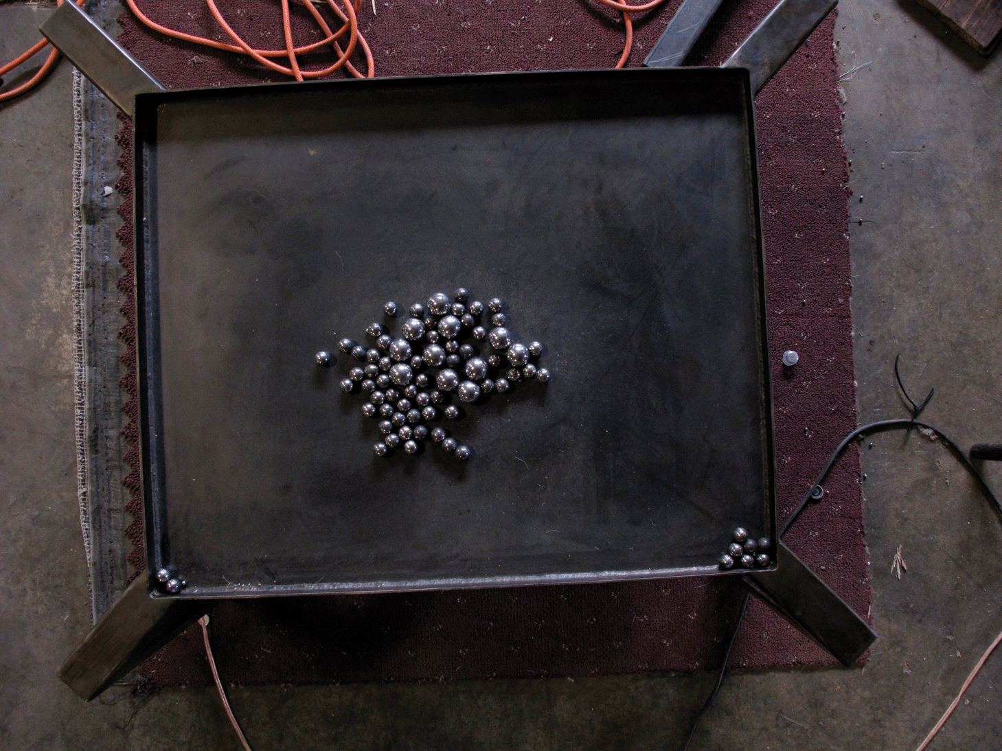 Photo by Fionn Reilly. One of Kris Perry’s unnamed “Machines,” which uses an embedded speaker to rattle loose ball bearings over its steel surface.