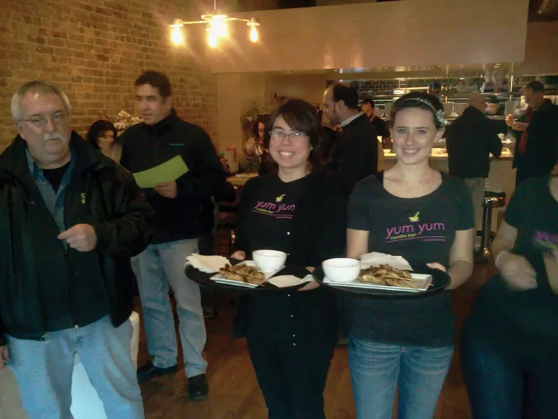 Servers offering free Asian-style goodies at the opening of Yum Yum Noodle Bar's Kingston location on February 18. - MARIO TORCHIO