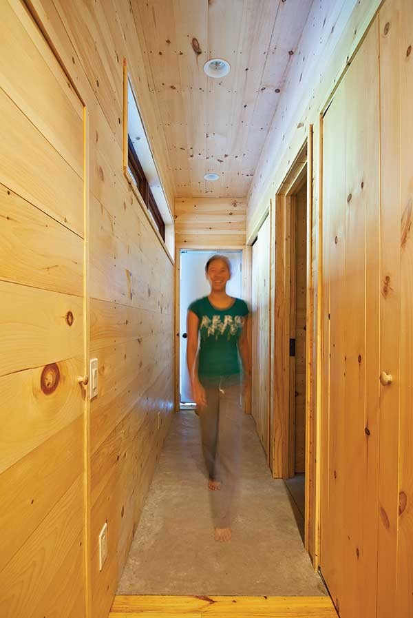 Suika Knowles in the narrow corridor connecting the bedroom and bathroom to the rest of the house.