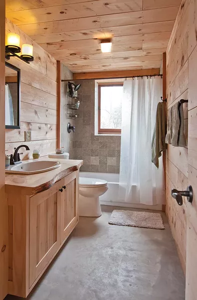 The bathroom tiles are cut limestone with visible embedded fossils. - DEBORAH DEGRAFFENREID