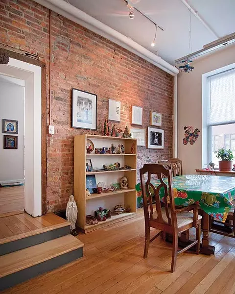 The dining area includes photos by internationally exhibited artists Billy Name and Robin Schwartz. The bookshelf is stacked with Mexican folk art. - DEBORAH DEGRAFFENREID