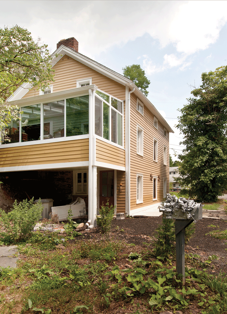 The second-story sunroom from Hudson Valley Sunrooms was added to the house in March 2010. In the foreground is Roland’s mailbox, adorned with her retired cordless telephone, plus a few other tchotchkes and found objects. - DEBORAH DEGRAFFENREID