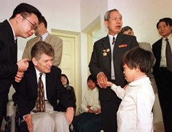 Tom Cory, national vice-president of the Vietnam Veterans of America (in wheelchair), is introduced to a young girl suffering birth defects due to her parentsâ€™ exposure to Agent Orange at the Vietnam Friendship Village hospital near Hanoi on January 4. During the Vietnam War, the US sprayed chemical defoliants over vast areas of the country. Vietnam says around two million adults were exposed and affected, while there are around 100,000 children who suffer defects due to their parentsâ€™ exposure.
