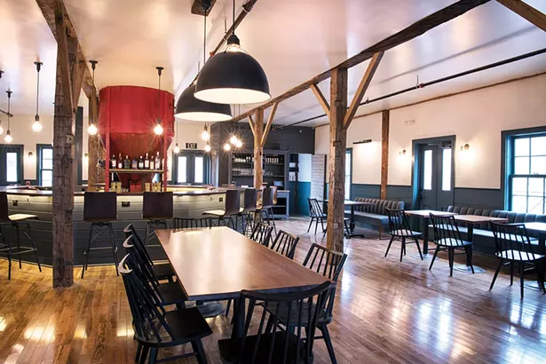 The centerpiece of the bar is a grain hopper, formerly used in the building’s incarnation as a feed store.