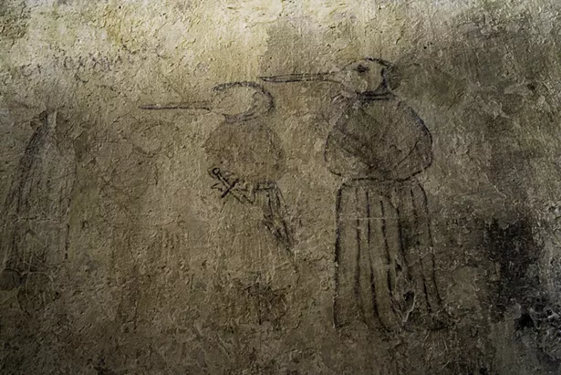 Wall drawing of a plague doctor.