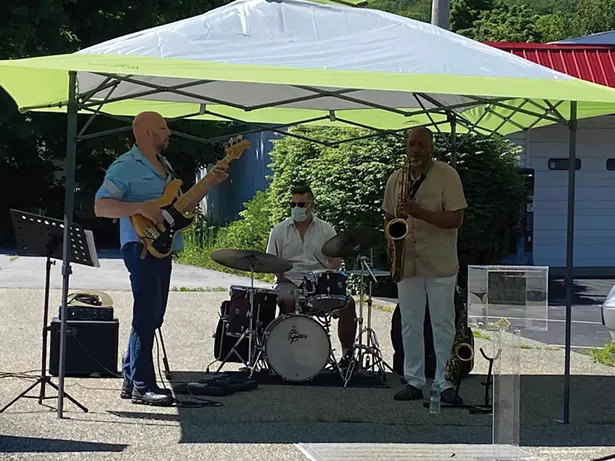 From left: Brian Kastan, Mike Pride, and Eric Person perform a free concert outside Kastan Art Space in Warwick on June 13 - PHOTO: MARIA KASTAN