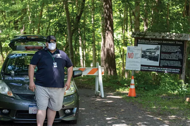 A Marbletown municipal employee guards the entrance to a path running along High Falls on July 5. Marbletown began posting a guard here after 18-yearold Chris Bamba drowned at High Falls on June 23.