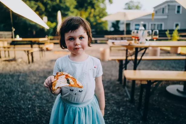 Elliott Goleman enjoys a slice of pizza. - JOSH GOLEMAN FOR OLLIE'S