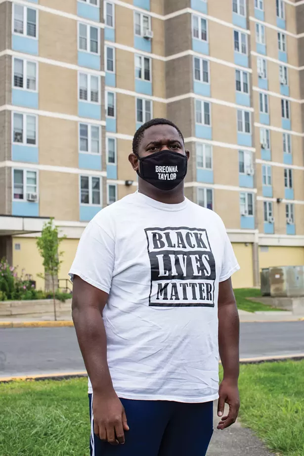 Quintin Cross in front of Bliss Towers, one of the only afforable housing developments in Hudson. - PHOTO BY ANGELINA DREEM