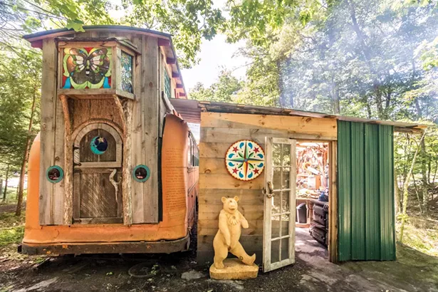 Quick is crafting a separate guest quarters in the style of a European Romani vardo wagon at his on-site wood working studio. Built on a hay wagon chassis, it will eventually have electricity and feature stained glass windows by Cassidy Ryan. - PHOTO BY WINONA BARTON-BALLENTINE