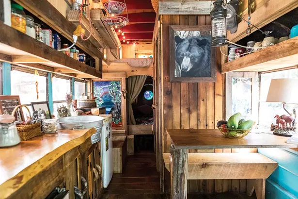 Quick tore out the interior of his bus and rebuilt it from boards from a close friend’s house and wood salvaged from a barn. “I don’t like taking down trees,” says Quick who mostly utilizes fallen logs or otherwise salvaged wood for his work. - PHOTO BY WINONA BARTON-BALLENTINE