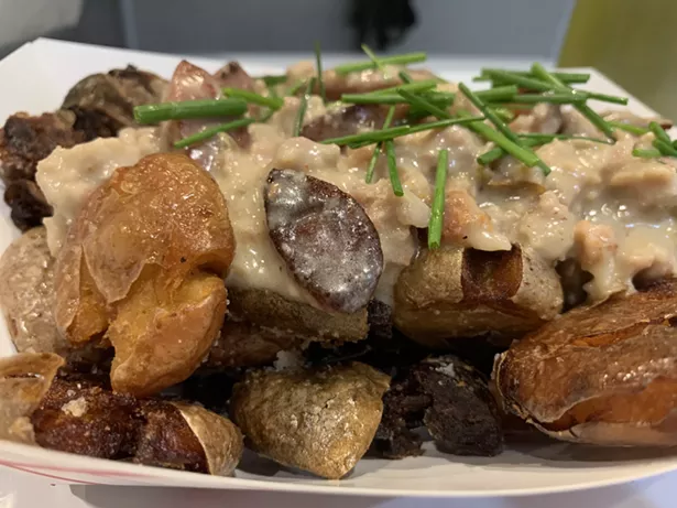 It's All Gravy, Baby: Smashed baby potatoes tossed with smoked kielbasa slices, smothered in sausage gravy, and sprinkled with chives.
