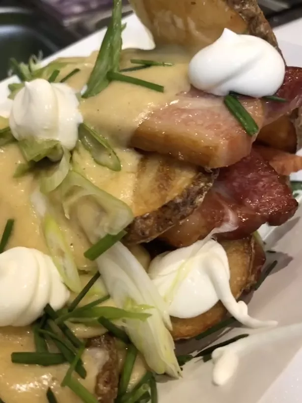 Potato planks topped with thick cut bacon drizzled with cheddar sauce, with sour cream, scallions, red onions, and chives.