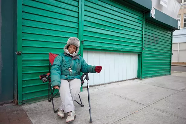 Carmen is a self-described “panhandler” who is so well known for sitting at the corner of Main and Catherine Streets that the mayor had a sign put up declaring the spot to be “Carmen’s Corner.” - PHOTO BY DAVID MCINTYRE