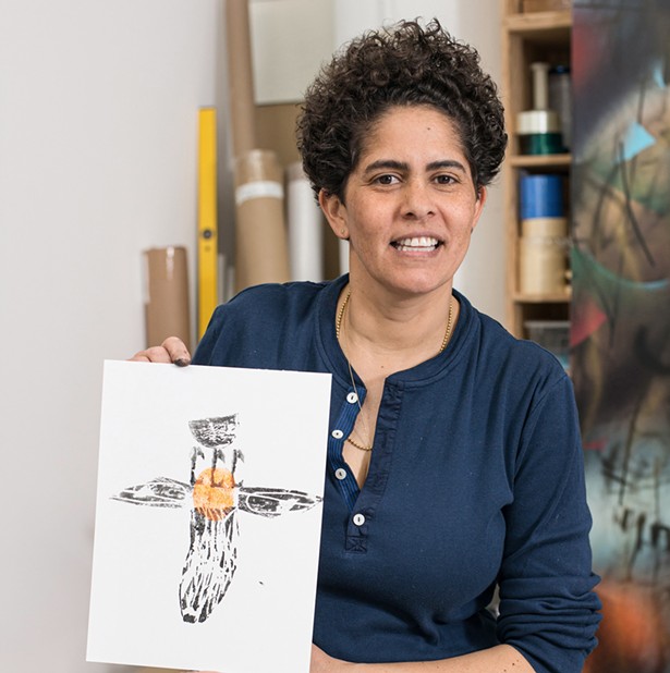 Julie Mehretu, with a print from a carved potato and sweet potato printing project. - PHOTO BY CASEY KELBAUGH