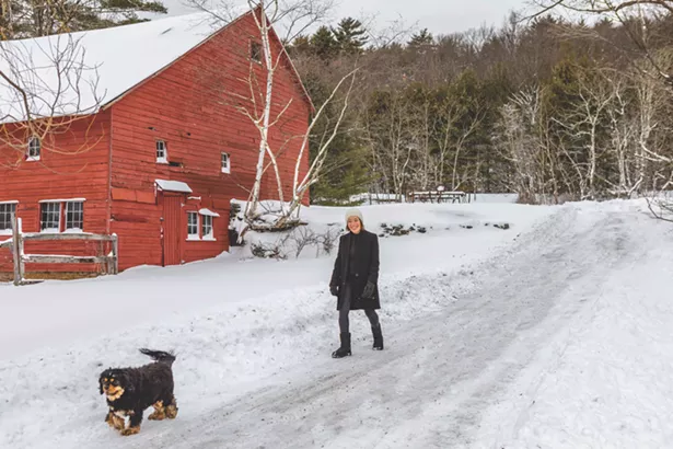 Ylvisaker and her dog Cooper walking the dirt road on her land. - The farmhouse design was inspired by the 1850s barn that sits at the front of her 22-acre property. “It’s the oldest barn in Woodstock,” she says. After many adventures, she finally returned to the area in 2000 and found the antique barn while driving by. In 2001, she designed and built her farmhouse to echo the themes of the historic barn. - WINONA BARTON BALLENTINE