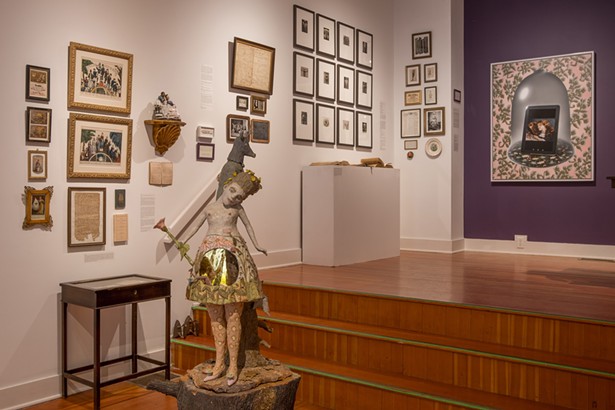 Foreground: "Mon Coiffure," Kathy Ruttenberg, 2019. Left to right: Misc. 18th to mid 19th century antiques and ephemera relating to “women’s work,” the cycle of life and death and women’s education. Includes Currier & Ives lithograph of "The Life and Age of Woman, Stages of a Woman’s Life from the Cradle to the Grave," 1850. "Pregnancy Test: Negative," Katrina Majkut. 2013. Twelve Images from the series Undergarment and Armor, Tanya Marcuse, 2002-2004. Antique and reproduced ephemera and antiques related to corsets and 19th c. dress reform, including pin cushion by artist Claudia McNulty. "Walled Garden; A Man Looking at a Woman Looking at Herself (Jo, La Belle Irlandaise, Gustave Courbet, 1865/66)," Tricia Wright, 2017. - JOHN KLEINHANS