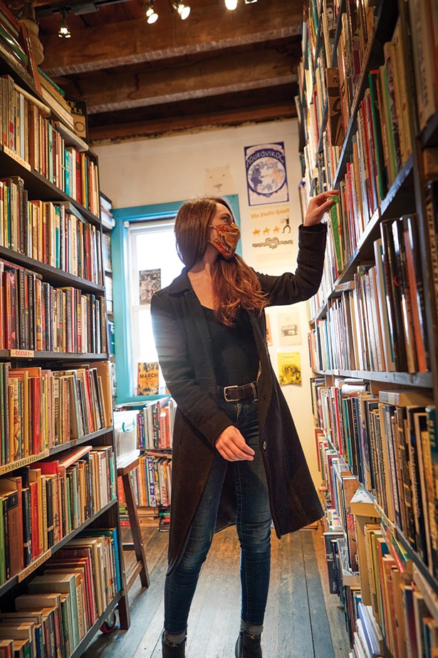Bookseller Laura Bellizzi in the stacks at Binnacle Books. - DAVID MCINTYRE
