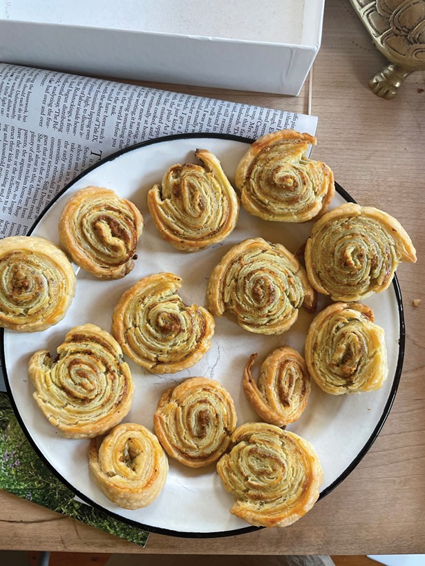 Leftover pesto rolled in cream cheese dough pinwheels and baked into a cocktail snack.
