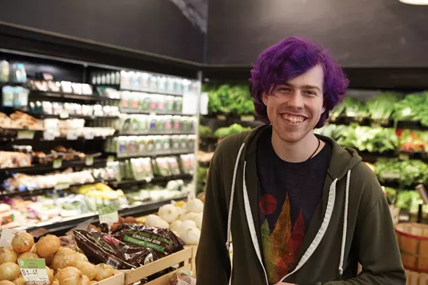 Duncan Dempsey in the produce section of Sunflower Natural Foods Market. - DAVID MCINTYRE