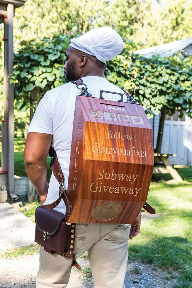 Jackson with the backpack he crafted for guerrilla marketing on the subway in New York City. His handcrafted raffle giveaways were a hit and he was gathering a growing following until the pandemic. He hopes to be back on the subway soon. - WINONA BARTON-BALLENTINE