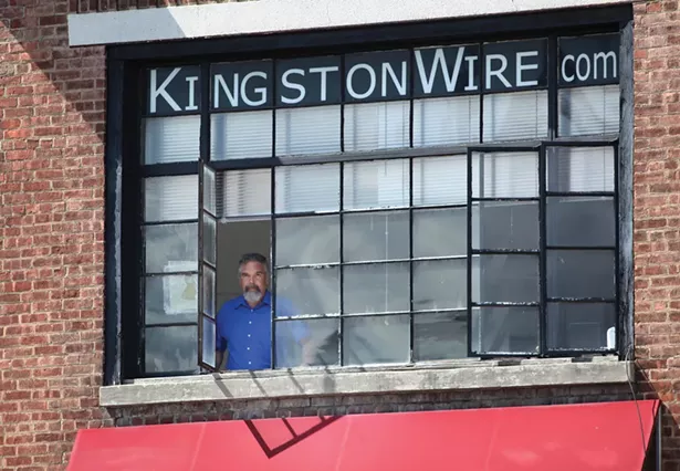 Reporter Jesse Smith in the Kingston Wire office overlooking the intersection of Broadway and Grand Street. Kingston Wire is a subscription-based digital newsroom covering the city that launched in 2020. - DAVID MCINTYRE