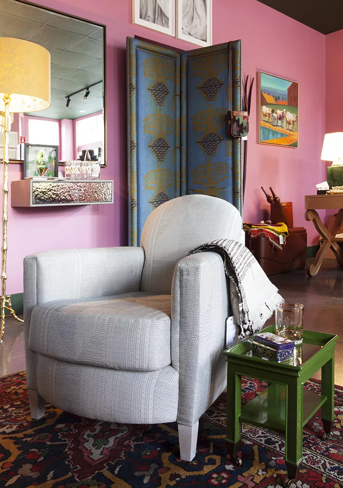 All the chairs can be made to order in any fabric, such as this French Club chair, bench-made in Brooklyn and covered in Pierre Frey fabric, which is part of House SFW's custom line. The French Club chair could be made to order with the customer's own material or the customer's own leather, and the leg finish can also be customized. - Many pieces from the custom line are peppered in throughout the space, such as the screen covered in a hand screened linen by Ted Tyler—each is shaped reminiscent of historic house styles with individually hammered nail heads along the frame and a hidden pocket for stashing slippers and magazines.