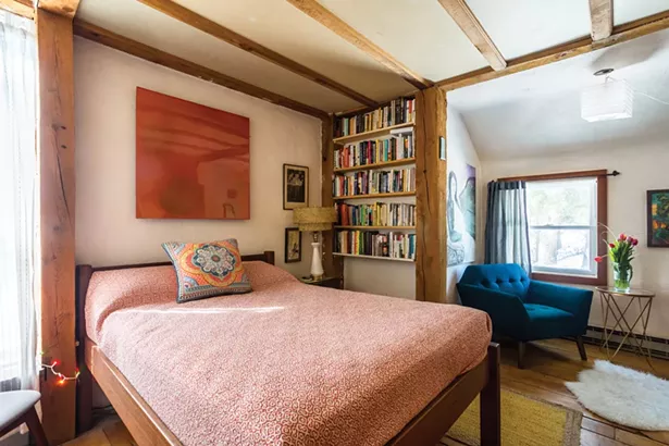 The home’s first-floor bedroom includes family heirlooms and much art. The orange epoxy painting above the bed is by Jones’s brother, Raphael Ben-Yehuda. The portrait above the blue chair was painted by Alberto Moretti of Jones’s mother, Cristina Ochagavia. Jones’s grandfather, Carlos Ochagavia, created the print of the tree depicting a scene from his life in Argentina. - WINONA BARTON-BALLENTINE
