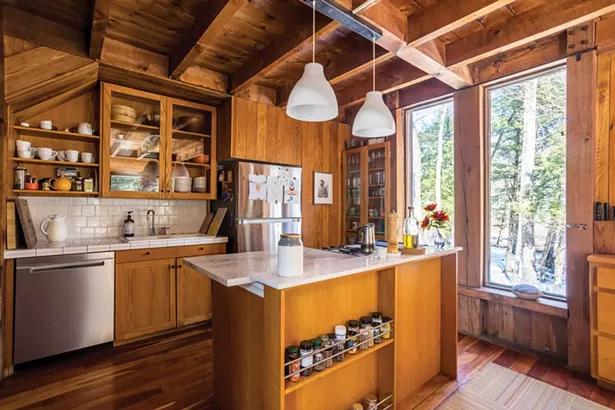 The home’s open kitchen “is the heart of the house, but also the most in need of a rethink,” says Jones. “My dad was an amazing cook. He would sit here playing solitaire and drinking Turkish coffee while his bread baked and his famous Iraqi dill chicken soup simmered.” A portrait of Ben-Yehuda hangs on the wall by the refrigerator. Jones hopes to add a picture window to the space and create a love seat underneath. - WINONA BARTON-BALLENTINE