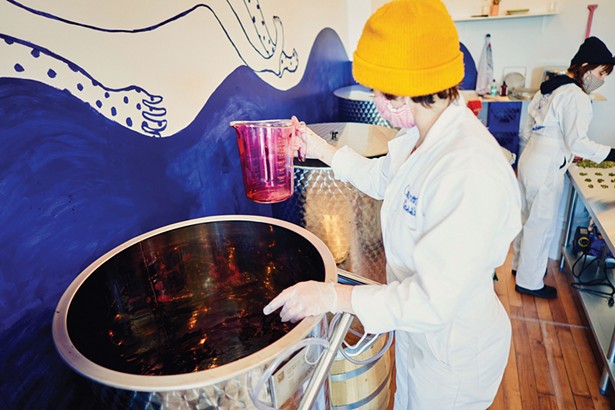Rachael Petach mixing up a batch of her currant liquer, C. Cassis. - PHOTO BY PHILLIP ANGERT