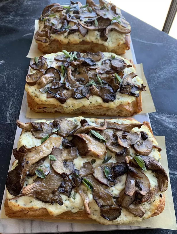 Mushroom focaccia ($9), also made in-house, is slathered in ricotta and served with fresh oregano, garlic, a drizzle of truffle oil, and flaky salt.