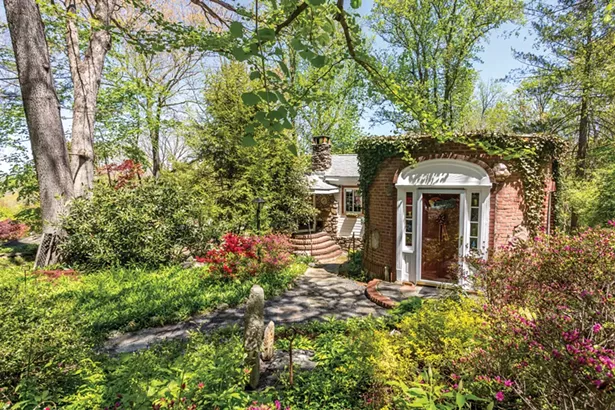 Sitting on a third of an acre, Daigle’s one-bedroom, one-bath home is a seamless amalgam of two very different styles and feels more spacious than its 1,000 square feet. The original cabin (to the left) was built in 1917 by a young Manhattan-based optometrist, Dr. Louis DeSantes. When DeSantes and his wife moved to the house full-time in the 1940s, they grafted the brick and stucco Mediterranean addition with a front entrance rotunda. Daigle utilizes the flat, Mediterranean-style roof for a vegetable garden. - WINONA BARTON-BALLENTINE