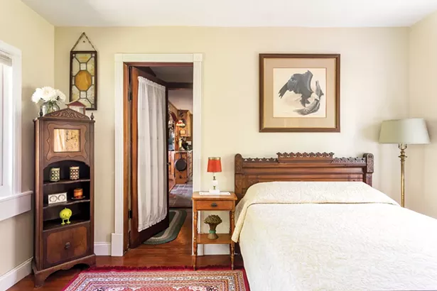 Originally two rooms, Daigle transformed the street-facing section of the addition into a guest room and has filled it with his estate sale finds, including an antique grandmother clock in the corner. “I love the quality and history of older furniture,” says Daigle. “Well taken care of pieces can last for generations and have so much character.” - WINONA BARTON-BALLENTINE
