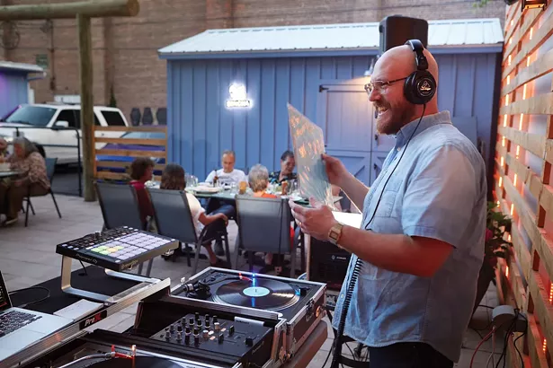 DJ Anthony Irwin spinning Thai vinyl at Isaan Thai Star’s new location on 7th Street. - DAVID MCINTYRE